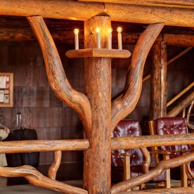 Interior details of lodgepole pine construction. Old Faithful Inn is a spectacular log (lodgepole pine) hotel that was initially built in the wunter of 1903-1904. It is the largest log hotel in the world and possibly even the largest log building in the world. There have been several additions made over the years to this building, but this lobby is original to 1903-1904. It remains a prime example of the "Golden Age" of rustic resort architecture (Robert Reamer was the architect).